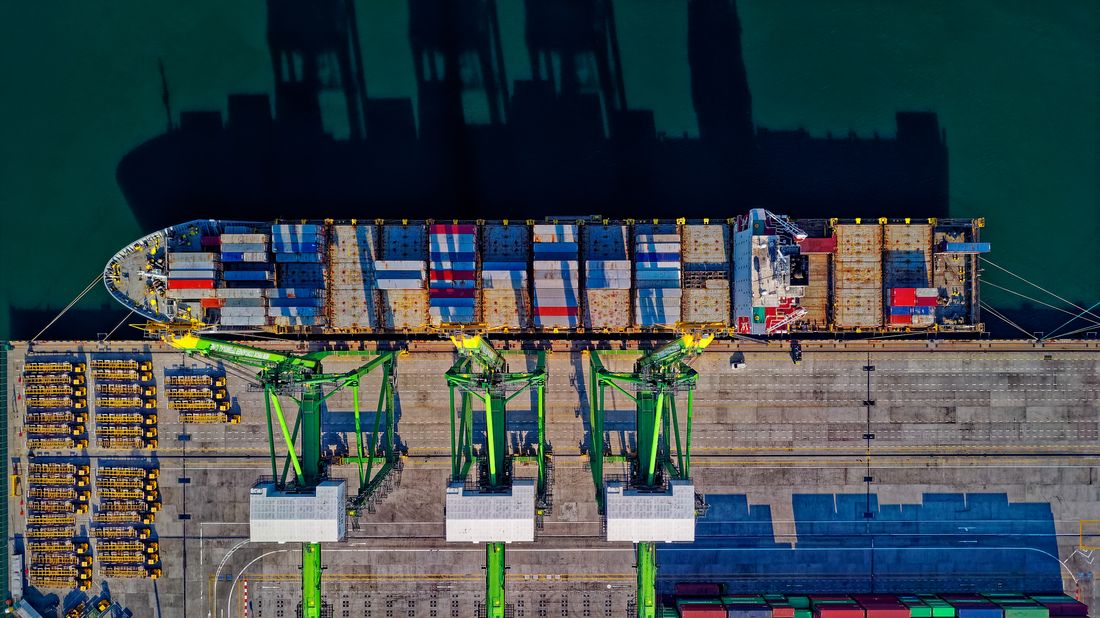 Large container ship loaded with cargo at sea